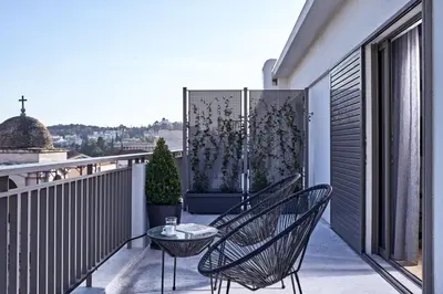 a balcony with two chairs and a table at MONO Lofts in Athens