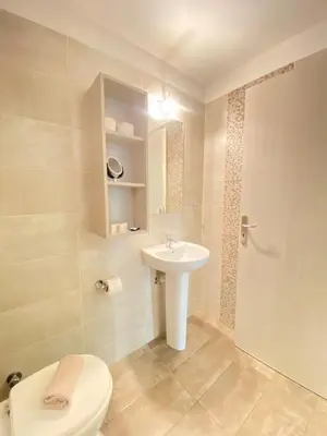 a bathroom with a toilet and a sink at Tins Athens in Athens