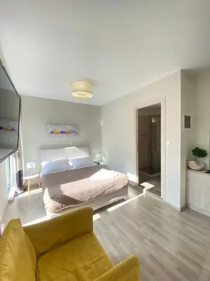a bedroom with a bed and a couch in it at Tins Athens in Athens