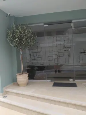 a potted tree in a glass display case at Elaėa Boutique Apartments in Piraeus