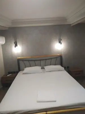a bedroom with a large white bed with two pillows at Elaėa Boutique Apartments in Piraeus