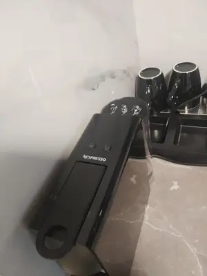 a remote control on a stove in a kitchen at Elaėa Boutique Apartments in Piraeus