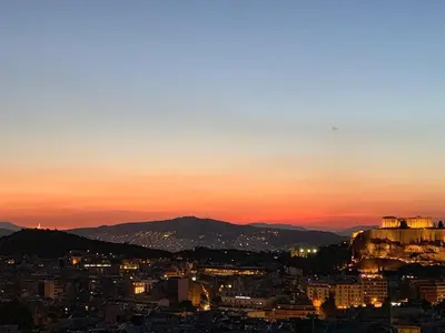 a view of a city at sunset at Acropolis View in Athens