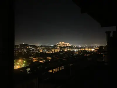 a view of a city at night at Acropolis View in Athens