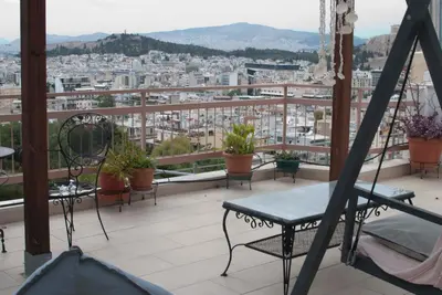 a balcony with chairs and a view of a city at Acropolis View in Athens