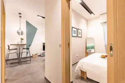 a room with a bed and a table with chairs at Ports Crossroad A in Piraeus