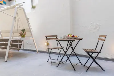 a table and chairs in a room with a ladder at Ports Crossroad A in Piraeus