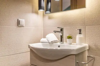 a bathroom with a sink and a mirror at Ports Crossroad A in Piraeus