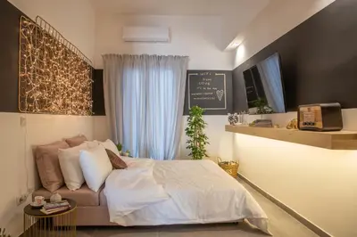 a bedroom with a bed and a chalkboard on the wall at Ports Crossroad D in Piraeus