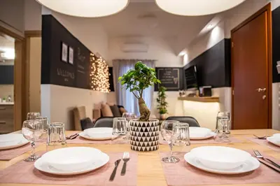 a table with white plates and a potted plant on it at Ports Crossroad D in Piraeus