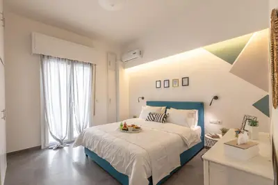 a bedroom with a large bed with a blue headboard at Ports Crossroad D in Piraeus