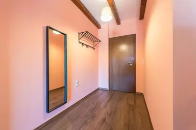 a hallway with a door and a mirror at Incredible Acropolis View Flat! in Athens