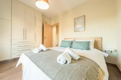 a bedroom with two towels on a bed at Incredible Acropolis View Flat! in Athens