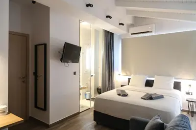a hotel room with a bed and a tv at Triple A - Acropolis View in Psiri Athens - FREE Parking! in Athens