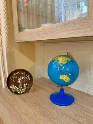 a blue globe sitting on top of a table at Sofia's Seaview Villa Near Airport And Beach in Artemida