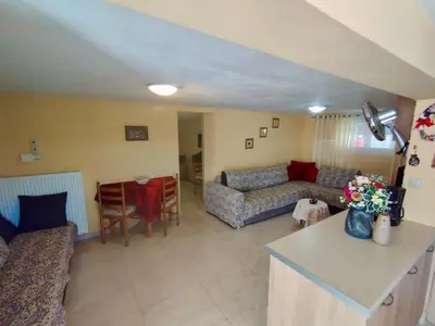 a living room with a couch and a table at Sofia's Seaview Villa Near Airport And Beach in Artemida