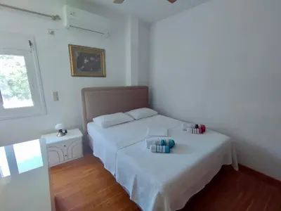 a bedroom with two beds and a window at Sofia's Seaview Villa Near Airport And Beach in Artemida