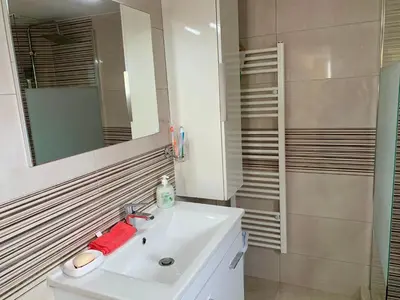 a bathroom with a white sink and a mirror at Sofia's Seaview Villa Near Airport And Beach in Artemida