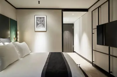 a bedroom with a bed and a flat screen tv at Academias Hotel, Autograph Collection in Athens