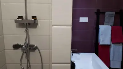 a bathroom with a shower and a sink and a tub at Tonias house in Athens in Athens