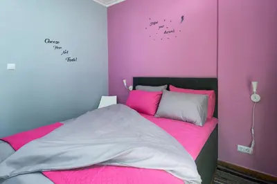 a bedroom with pink and purple walls and a bed at Tonias house in Athens in Athens