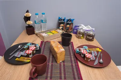 a table with two plates of food and bottles of water at Tonias house in Athens in Athens