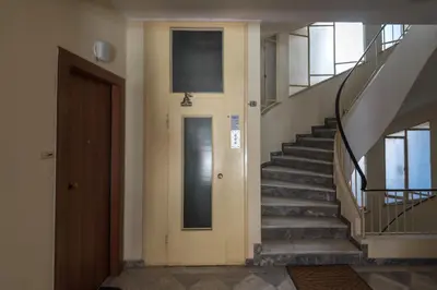 a staircase in a building with a door and a stair case at Tonias house in Athens in Athens