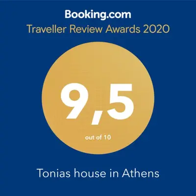 a yellow circle with the number nine and the text travelling review awards at Tonias house in Athens in Athens