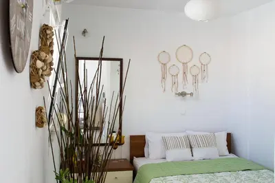 a living room with a mirror and a bed at INSPIRATION Guestroom with Amazing Roof Garden in Athens