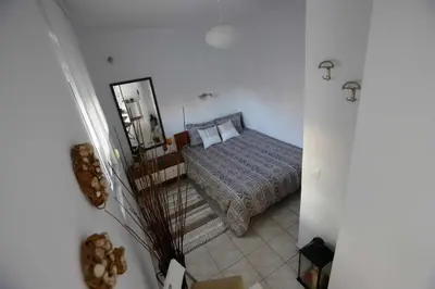 a bedroom with a bed and a mirror at INSPIRATION Guestroom with Amazing Roof Garden in Athens