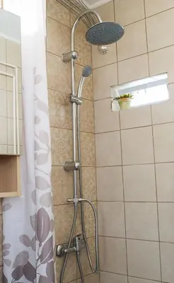 a shower with a shower head in a bathroom at INSPIRATION Guestroom with Amazing Roof Garden in Athens