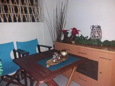 a wooden table with two chairs and a wooden desk at INSPIRATION Guestroom with Amazing Roof Garden in Athens