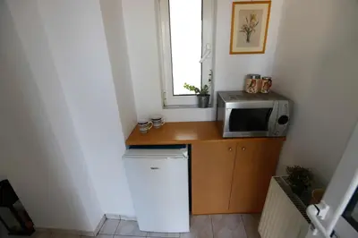 a small kitchen with a microwave and a counter at INSPIRATION Guestroom with Amazing Roof Garden in Athens
