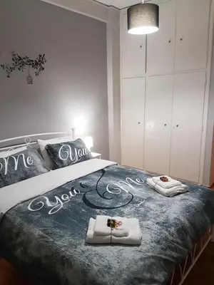 a bedroom with a bed with towels on it at Katehaki Metro Flat in Athens