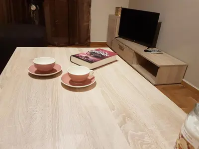 two cups and saucers on a table in a living room at Katehaki Metro Flat in Athens