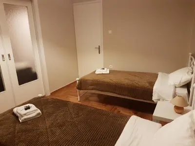 a small room with two beds and a mirror at Katehaki Metro Flat in Athens