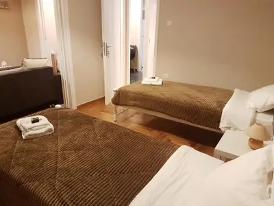 a hotel room with two beds in a room at Katehaki Metro Flat in Athens