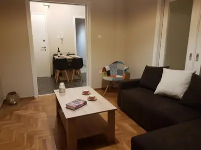 a living room with a couch and a table at Katehaki Metro Flat in Athens