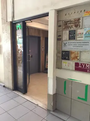 an entrance to a building with a revolving door at Downtown Glyfada smart apartment in Athens