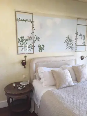 a bedroom with a bed with a table next to it at Luxury Penthouse with Private Roof Swimming Pool in Athens