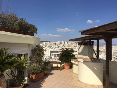 a balcony with a view of a city at Luxury Penthouse with Private Roof Swimming Pool in Athens