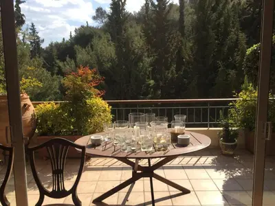 a table with glasses on it on a patio at Luxury Penthouse with Private Roof Swimming Pool in Athens