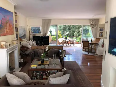 a living room with a couch and a table at Luxury Penthouse with Private Roof Swimming Pool in Athens