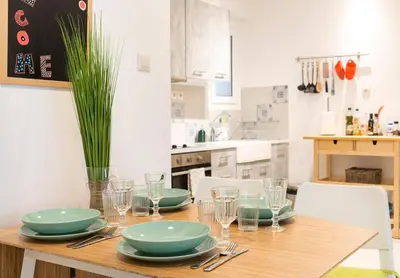 a dining room table with plates and glasses on it at 1 KM from The Acropolis 1 Bedroom Apt in Athens