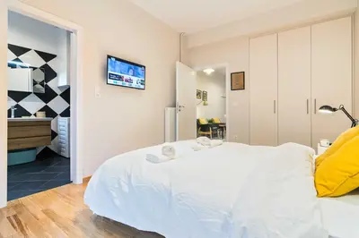 a bedroom with a large white bed and a tv at Athens' Top Location Romantic & Well Decor Shining Star in Athens