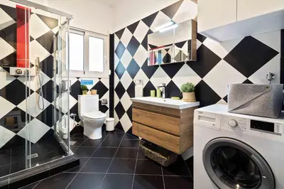 a bathroom with a washing machine and a washer at Athens' Top Location Romantic & Well Decor Shining Star in Athens