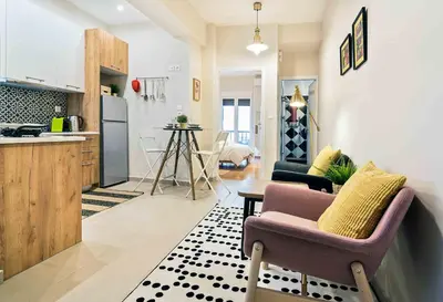 a kitchen and living room with a couch and a table at Athens' Top Location Romantic & Well Decor Shining Star in Athens