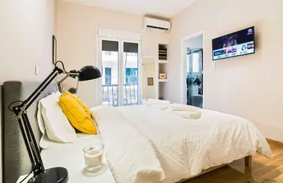 a bedroom with a bed and a lamp on a table at Athens' Top Location Romantic & Well Decor Shining Star in Athens
