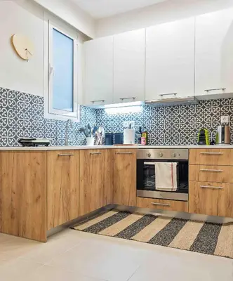 a kitchen with wooden cabinets and blue and white tiles at Athens' Top Location Romantic & Well Decor Shining Star in Athens