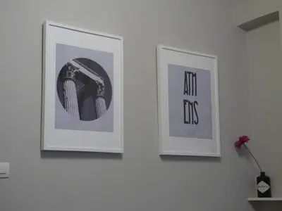 two framed pictures on a wall in a room at Your stay next to Acropolis! in Athens